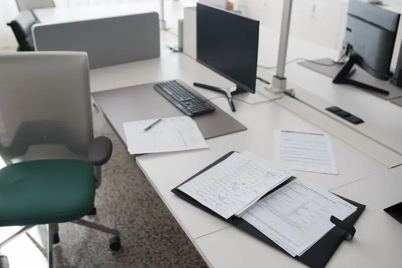 Clean office desk with documents and a computer