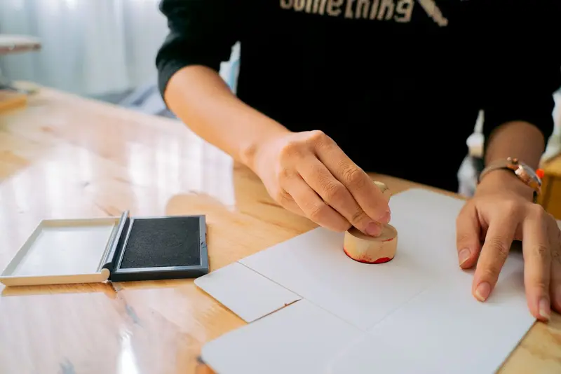 Hand stamping a document at a desk