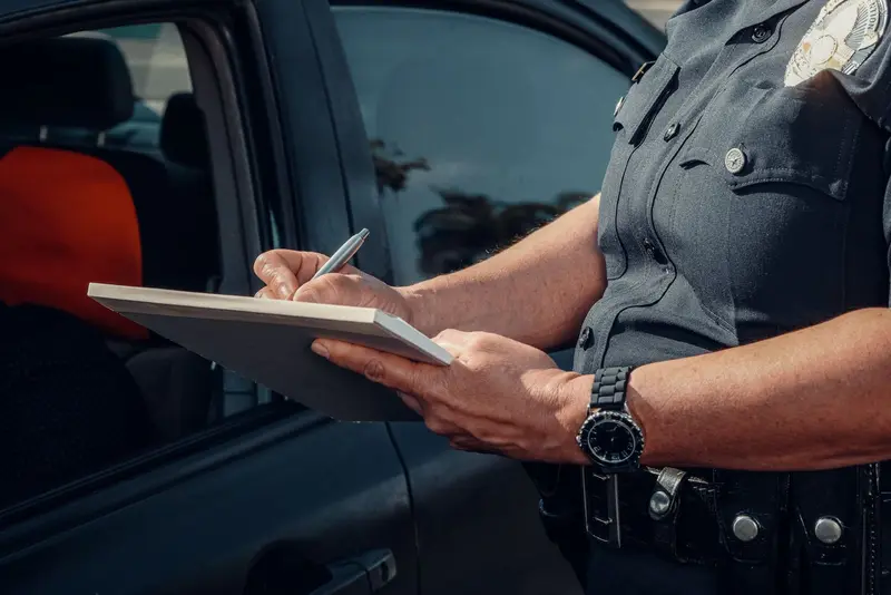 Police officer filling in an official form
