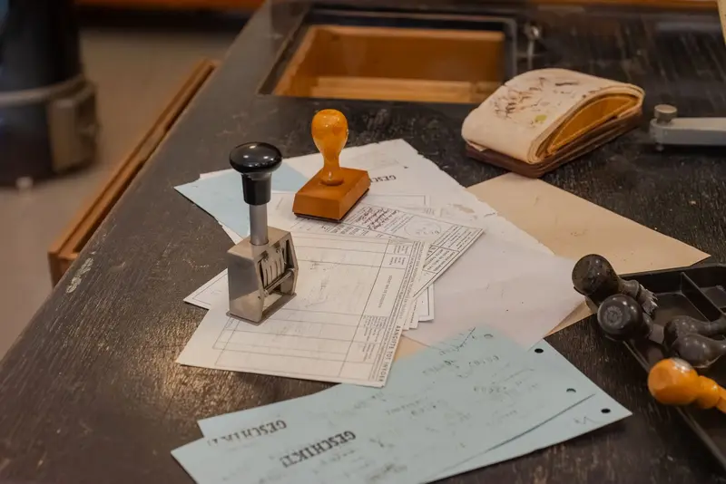 Rubber stamps and filled-in registry forms on a records office desk
