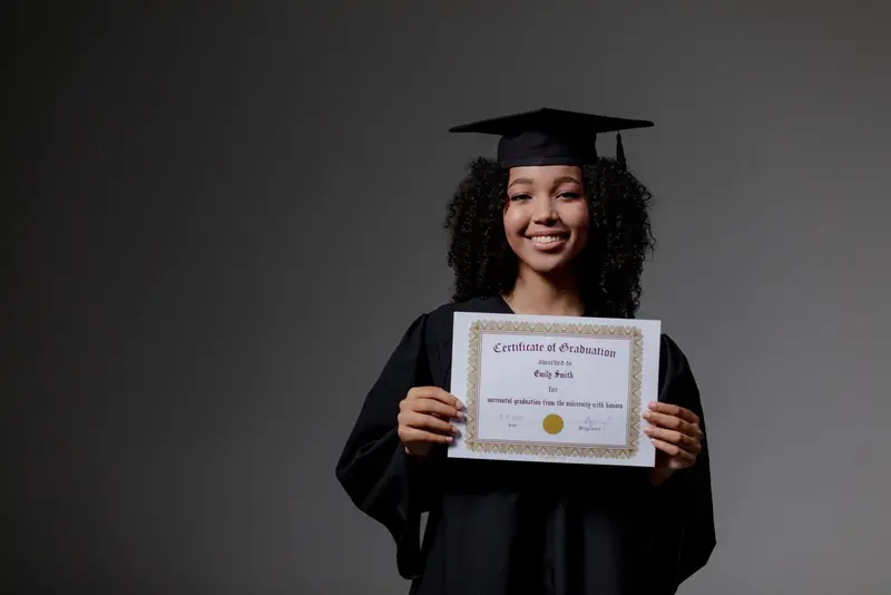 Student in a graduation gown holding a school certificate