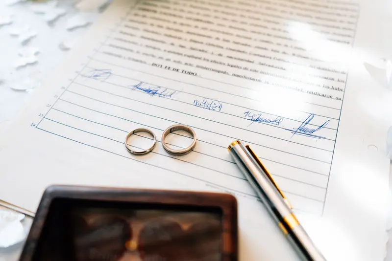 Two wedding rings on a signed marriage certificate